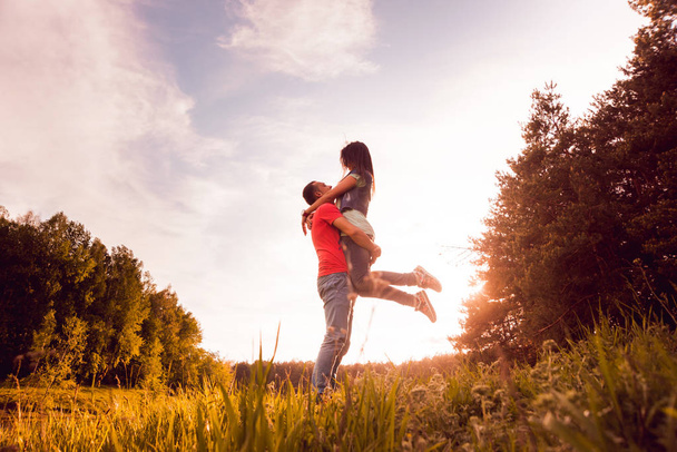 Young couple having good time at sunset in park - Foto, Imagem