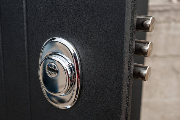  lock in a metal black door - Foto, Bild
