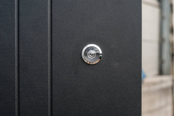 Eyelash in a black metal apartment door - Фото, изображение