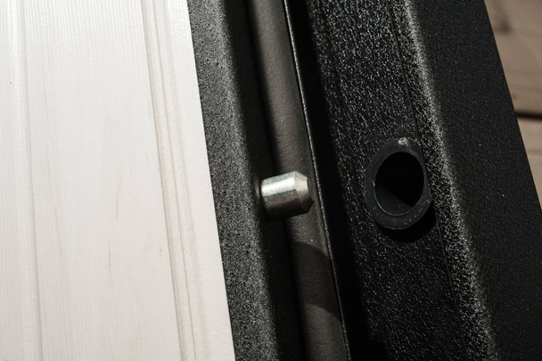 Anti-burglar equipment of the outside apartment metal door. Metal pin and hole in the end of the door - Foto, imagen