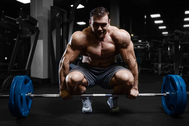 Brutal strong bodybuilder athletic men pumping up muscles with d - Fotografie, Obrázek