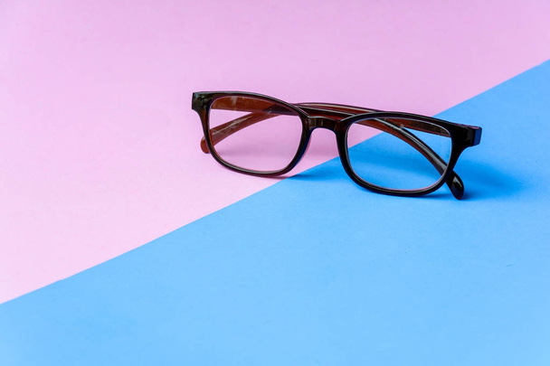 black glasses and pink blue background - Photo, Image