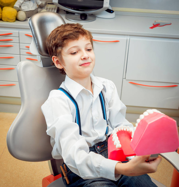 Little cheerful caucasian boy in the dental office. - Фото, изображение