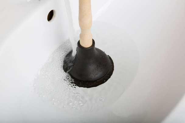 Suction and clogging of the sink - Photo, Image