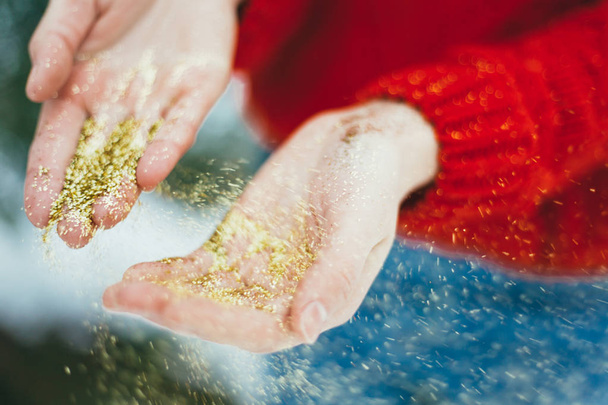 Golden glitter in hands - Photo, Image