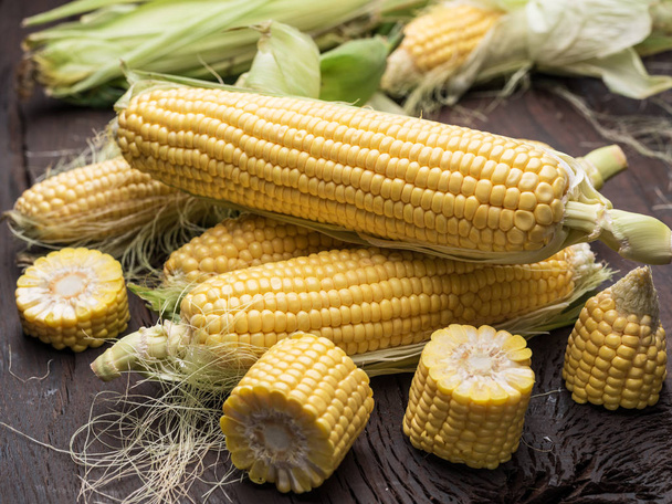 Ear of maize or corn on the dark wooden background. - Фото, зображення