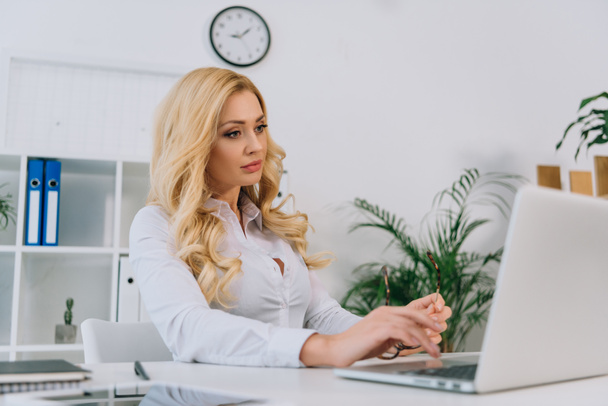 beautiful businesswoman working at laptop in office - Photo, Image