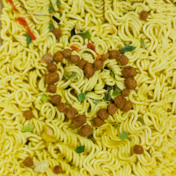 A heart of spices and soy meat on instant noodles cooking. The concept of love for fast food. Prepared with Love - Photo, Image