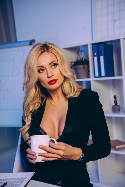 seductive blonde woman holding cup of coffee - Fotografie, Obrázek