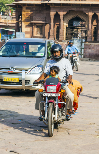 man and child on a motorbike at the Sadar market at the clocktow - Foto, Imagen