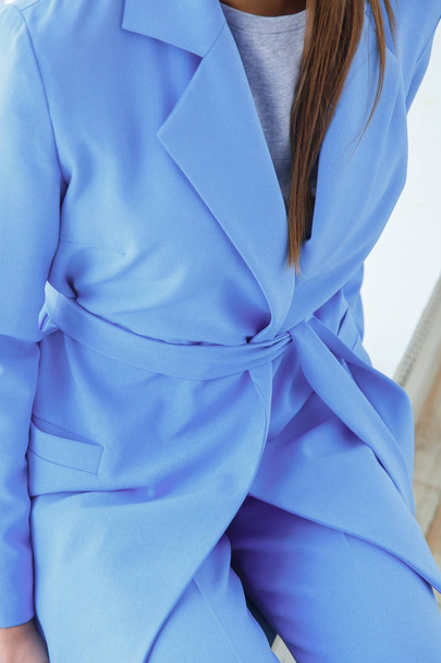 Closeup of beautiful young woman in casual blue pantsuit - Foto, imagen
