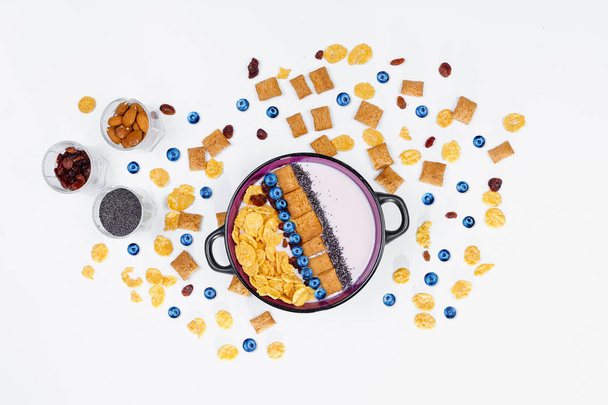Breakfast, bowl with homemade yogurt and cornflakes and fresh blueberries on white background, top view, flat lay. Concept of healthy food, healthy food, detox. Copy Space - Φωτογραφία, εικόνα