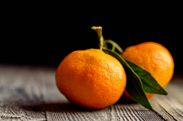 Mandarine orange or tangerine on wooden board - Фото, изображение