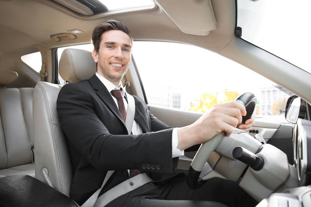 Businessman in driver's seat of car - Zdjęcie, obraz