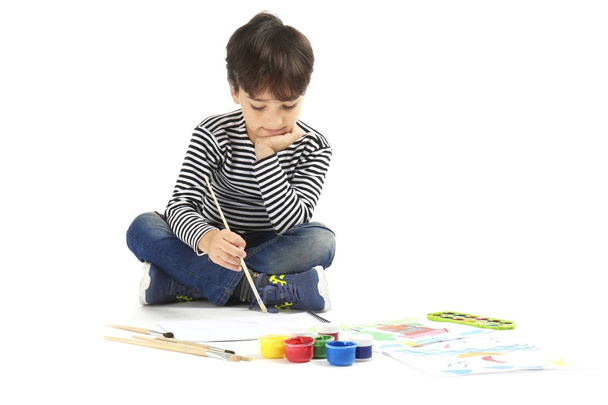 Little boy painting against white background - Foto, immagini