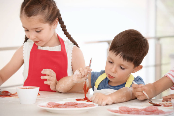 Cute children in kitchen during cooking classes - Foto, afbeelding