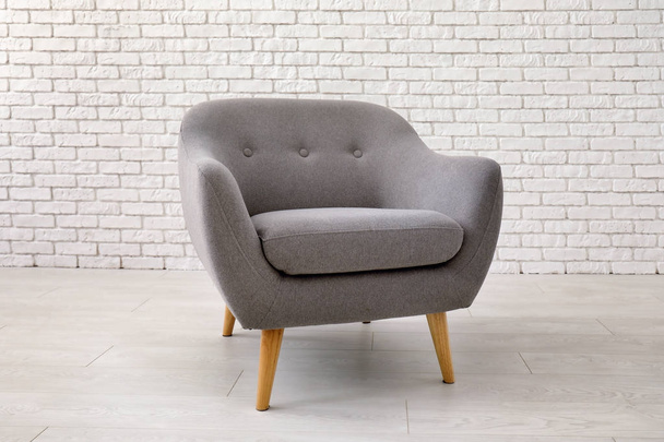 Comfortable armchair near brick wall - Foto, Imagen