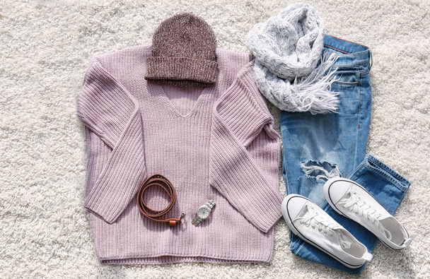 Set of stylish female clothes and accessories on fluffy carpet - Foto, Imagem