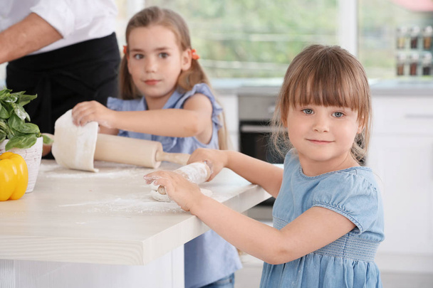Cute children in kitchen during cooking classes - Photo, image