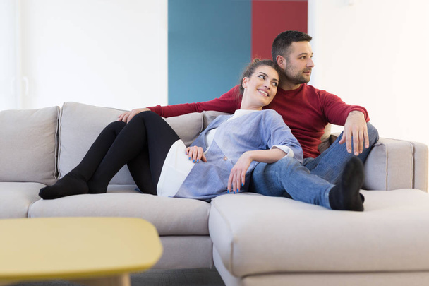 couple hugging and relaxing on sofa - Foto, imagen