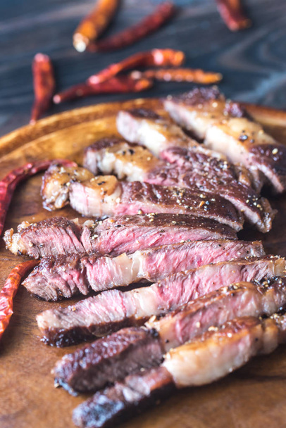 Cut beef steak on the wooden board - 写真・画像