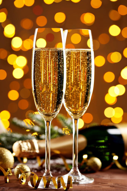 Champagne glasses with bottle on lights background - Photo, image