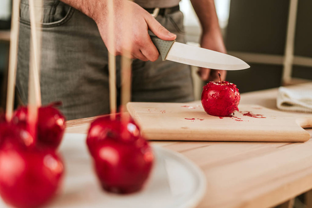 Hand  slicing candy apple. - Photo, Image