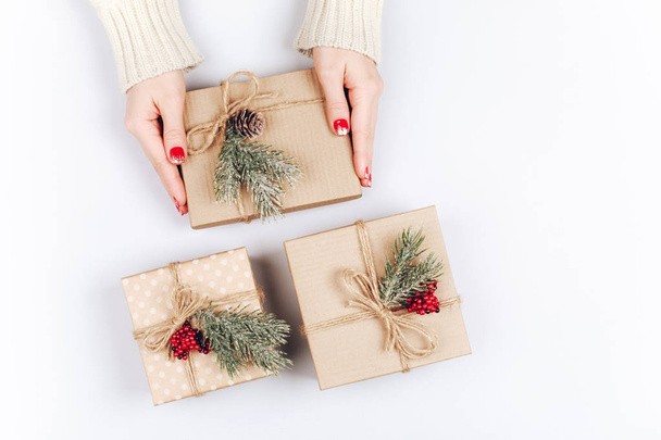 Woman's hands and three Christmas gift boxes - Foto, Bild
