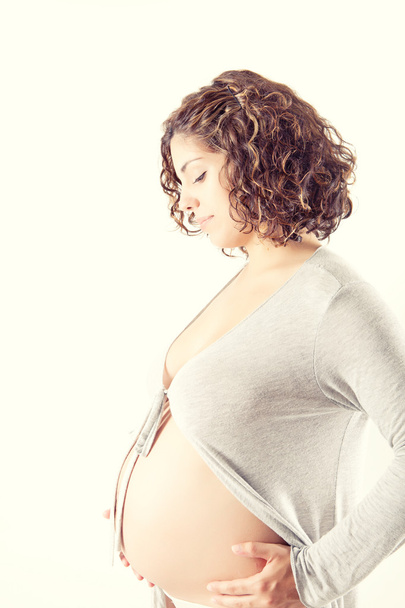Beautiful pregnant woman showing her good shape - Foto, Imagen