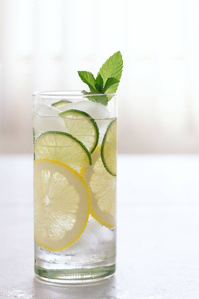 Fresh cocktail with soda, lime, lemon on a marble background - Photo, Image