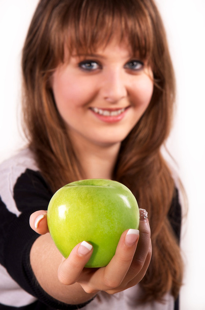 Teen girl and an apple - Zdjęcie, obraz