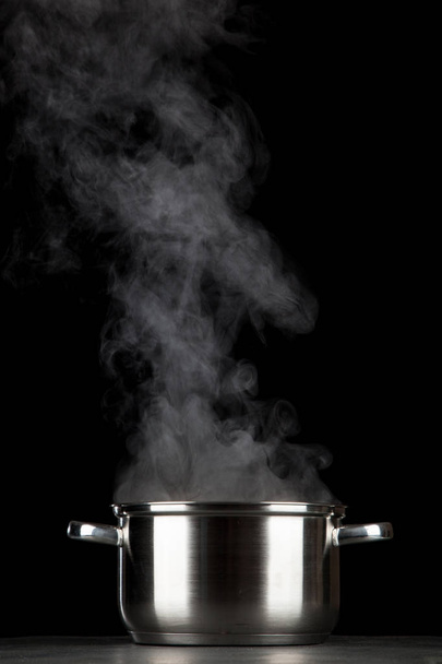 Steaming pot on black background - Foto, Imagem