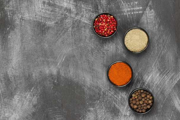 Various pepper on a black background. Top view, copy space. Food - Zdjęcie, obraz