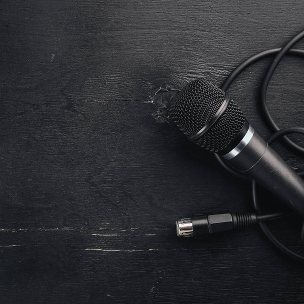 Microphone on a wooden black table. Studio. Top view. Free space for text. Copy space. - Photo, Image