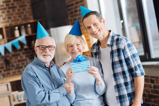 Upbeat father and son posing with mother celebrating birthday - Fotoğraf, Görsel