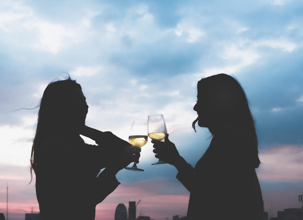 silhouette two asia lesbian lgbt couple toast champagne glass at - Foto, immagini