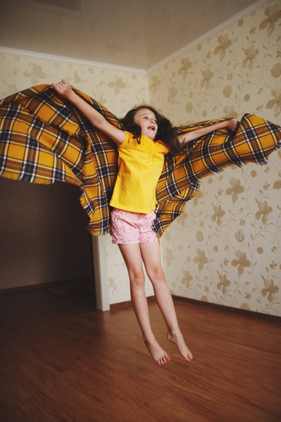 little girl with plaid at home - Foto, imagen