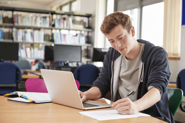 Male Student Working At Laptop  - Фото, изображение
