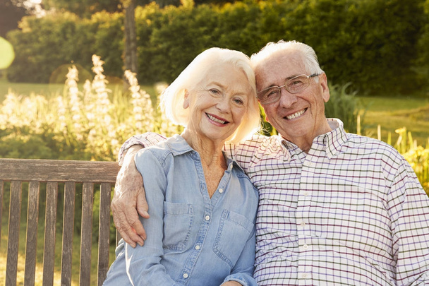 Senior Couple Sitting On Garden Bench - Photo, image