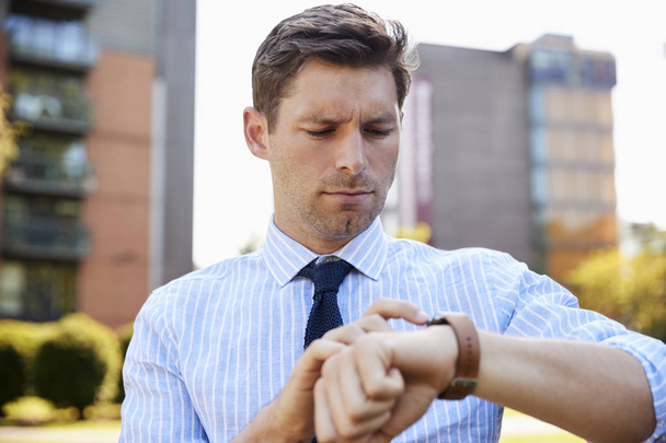 Businessman looking at smart watch  - Φωτογραφία, εικόνα