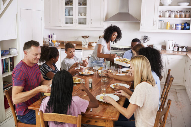 Two Families Enjoying Eating Meal  - Foto, afbeelding