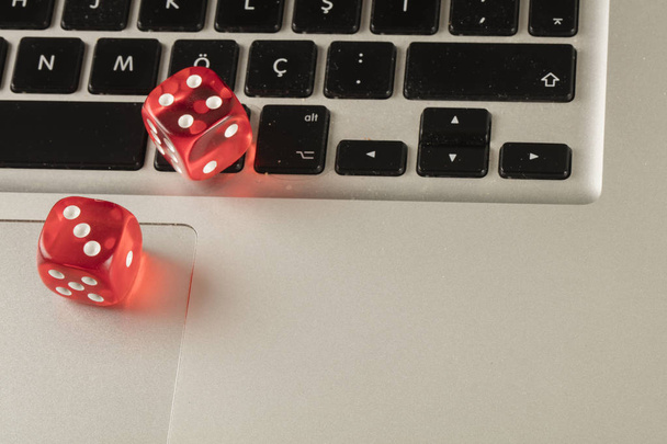 red color dice on keyboard close up - Φωτογραφία, εικόνα