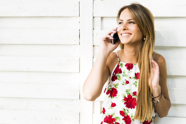 woman smiling during a phone call - Foto, imagen
