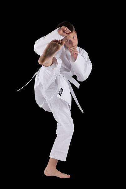 boy posing with karate techniques in studio on black background isolated - Photo, Image