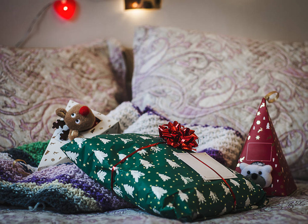 Gifts on the bed. Christmas or St. Valentine concept - Foto, Imagem