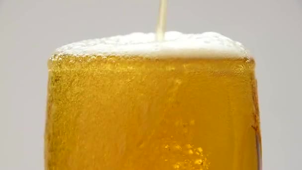 Close-up van gieten bier met bubbels in glas - Video