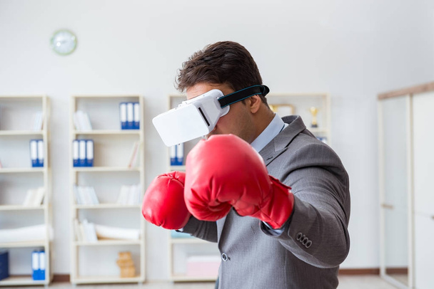 Man boxing in the office with virtual reality goggles - Foto, Imagem