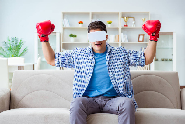 Sanal gerçeklik gözlüğü takan adam boks oyunu oynuyor. - Fotoğraf, Görsel