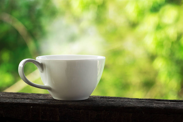white coffee cup with green bokeh background - Foto, afbeelding