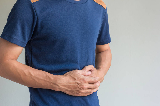 man have stomachache on gray background - Фото, зображення